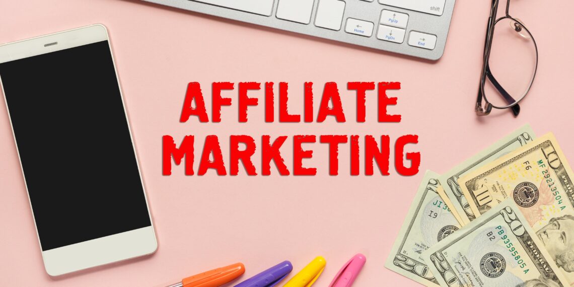 a phone, a keyboard and money - affiliate marketing desk