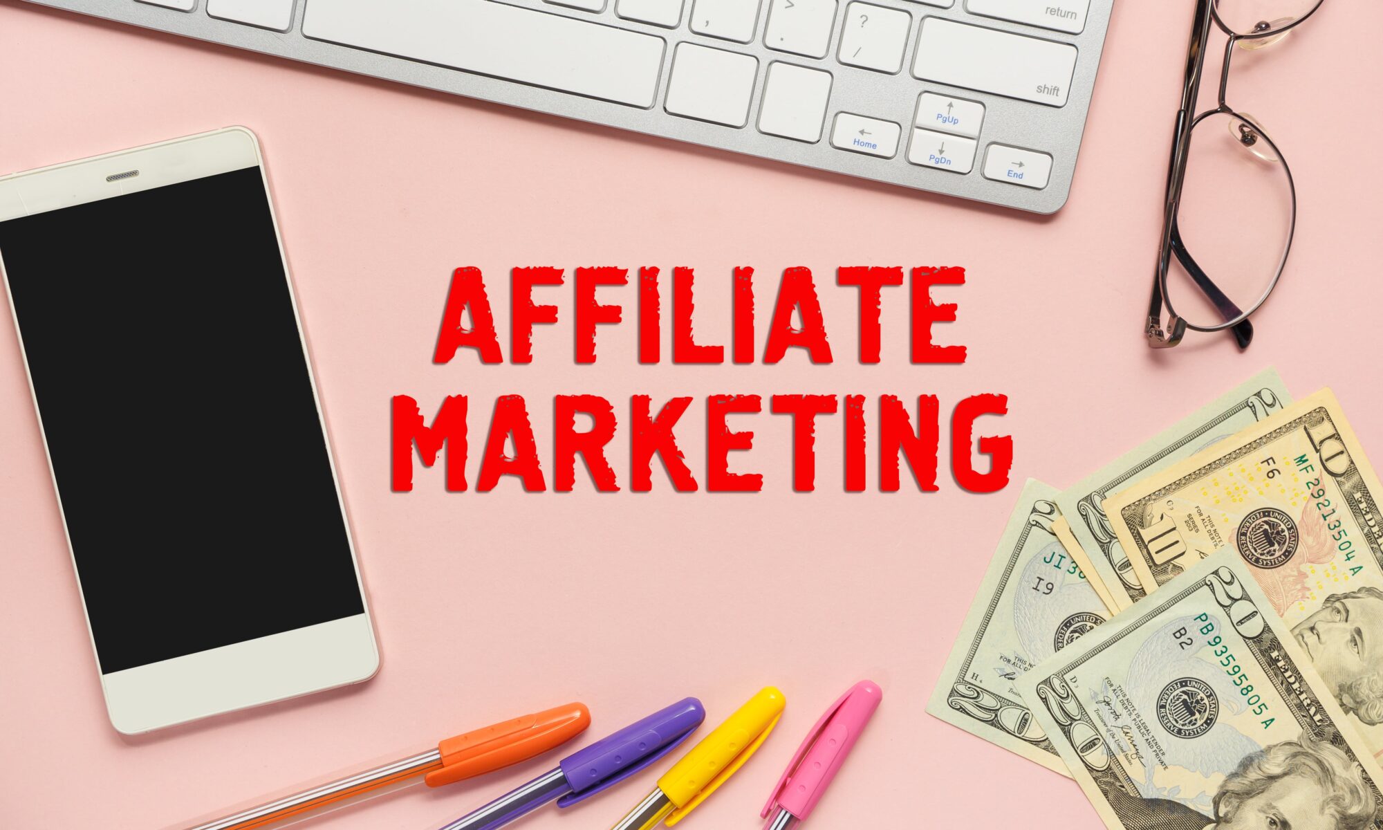 a phone, a keyboard and money - affiliate marketing desk