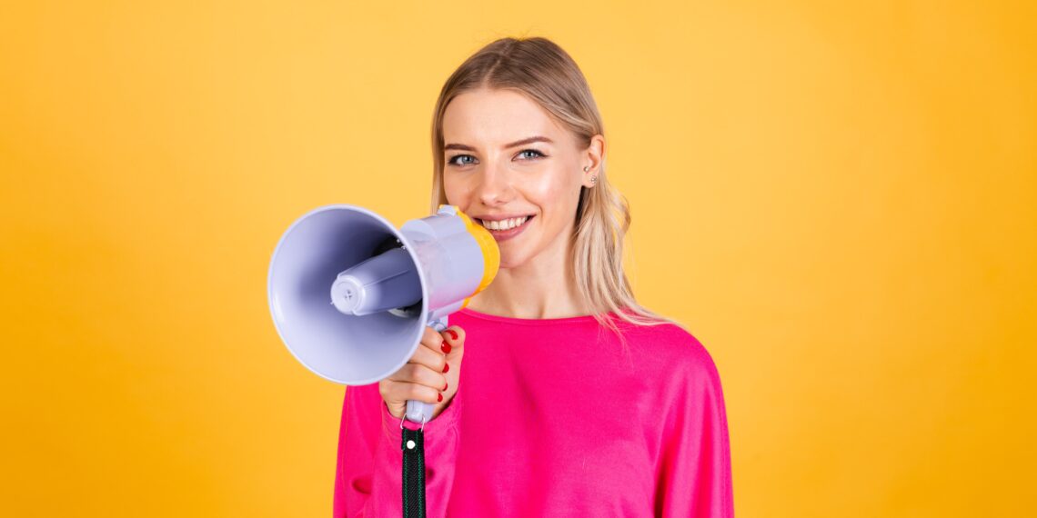 A woman holding a loudspeaker